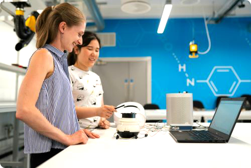 Two Ladies in a Computer Lab with a Laptop